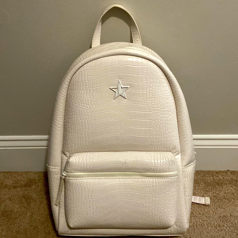 Cream colored Jeffree Star faux alligator backpack with red crossbody canvas bag